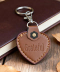 Leather heart keychain with 'Grateful' text, attached to a Dope 8 Piece Leather Magnetic Snap Buttons Flower Shape for Purses and Wallets clasp