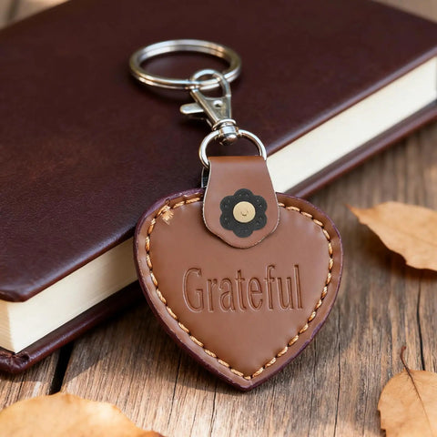 Leather heart keychain with 'Grateful' text, attached to a Dope 8 Piece Leather Magnetic Snap Buttons Flower Shape for Purses and Wallets clasp