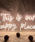 Customizable Neon Sign For Wall Decor Warm White LED Neon Light With Sturdy Acrylic Backplate 19.7 Inch By 9.8 Inch Indoor Display Ideal For Birthday Parties Weddings Christmas Living Rooms And Epic Gift For Adults Teens displaying 'This is our happy place' on lace background.