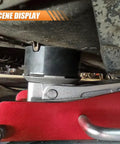 Heavy Duty Rubber Cross Slotted Jack Adapter Puck Pad With Anti Slip Pinch Weld Side Support Block For Universal Car Lifts and Floor Jacks, positioned under vehicle.