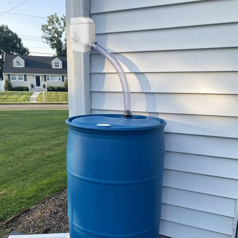 Universal Gutter Downspout Diverter With Built In Filter Screen White Fits 2x3 And Oversize 3x4 Downspouts Reversible Spout For Left Or Right Install Easy No Fuss Setup installed on gutter with hose to blue rain barrel