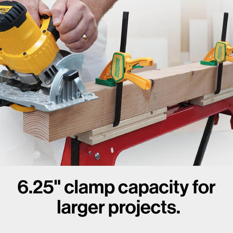 Person using a yellow saw with Grr-rip Grip-Strong Dovetail Clamps Two-Pack For Woodworking Jigs And Sleds on a workbench.