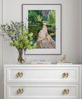 Gold Bow Cabinet Knobs Set Two Pack Brass Finish Bow Shaped Pulls on white dresser drawers in a room with framed artwork.