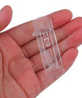 Hand holding transparent pin from Durable Plastic Shelf Support Clips 10 Pack ABS Shelf Pins For Easy Adjustable Bookshelves Cabinets Cupboards