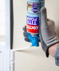 Person applying DIY Friendly Tite Foam Window And Door White Insulating Sealant High Density Expanding Foam For Gaps And Cracks