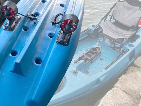 Blue kayak with attached Beefy Underwater Thruster Max 24V 1080W Brushless Motor with CCW Three Blade Nylon Propeller on shore