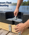 Hands installing Eight Piece Floating Dock Hardware Kit With Three Eighth Inch By Four Inch Hex Lag Bolts on a dock float.