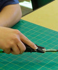 Person using Vane And Wrap Stripping Tool Pro Grade For Arrows With A Sharp Long Lasting Blade Safe Angled Cut Via Preformed Channel