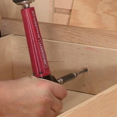 Drive90Plus Right Angle Drill Attachment in use for drilling in tight wooden space with Phillips driver bit and 1/4 inch hex bit compatibility.