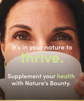 Woman enjoying a drink, promoting health with Nature's Bounty supplements for wellness and vitality.