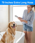 Woman using Extra Long 79 Inch Stainless Steel Shower Hose With Anti Kink Flex Handheld Hose for pet bathing in bathroom.