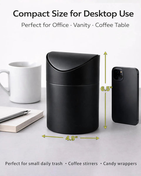 Tiny Matte Black Desktop Trash Can With Lid For Office Desk And Vanity 1.5 Liter Countertop Waste Bin next to a phone and coffee mug