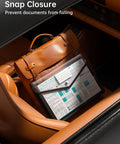 Black Transparent Expanding File Folder 7 Pack With Snap Closure placed on car seat next to brown leather bag showcasing document storage