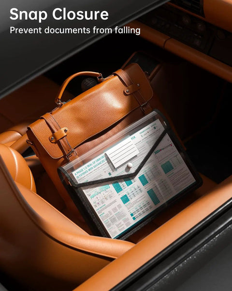 Black Transparent Expanding File Folder 7 Pack With Snap Closure placed on car seat next to brown leather bag showcasing document storage