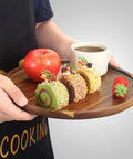 12 Inch Round Acacia Wood Serving Tray with desserts, apple, and coffee cup, natural kitchen dish holder for dining.