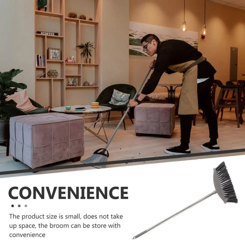 Dark Grey Angle Floor Broom With Long Stainless Steel Handle And Dense Stiff Bristles Snags Pet Hair Kitchen Messes And Daily Grime So Flipping Your Space Clean Is Total No Sweat Mode used for efficient cleaning in stylish living space.