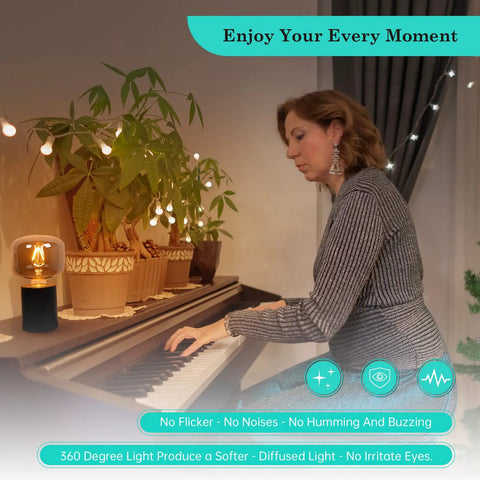 Woman playing piano beside large vintage E26 Edison LED globe bulb 20W equivalent dimmable 2200K soft warm smoky gray glass