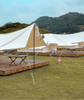 Tent setup with Eight Pack High Reflective 4mm Tent Guy Lines With Aluminum Tensioner, shown on grassy campsite, enhancing night visibility.