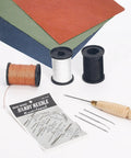 Three Spool Nylon Thread Sewing Kit With Pro Grade 3 Spools Of 80 Yards In Black White And Brown Heavy Duty Needles Set Five Straight And Two Curved Sewing Awl Ideal For Upholstery Leather Shoes And DIY Crafts, featuring threads and needles with awl on fabric.