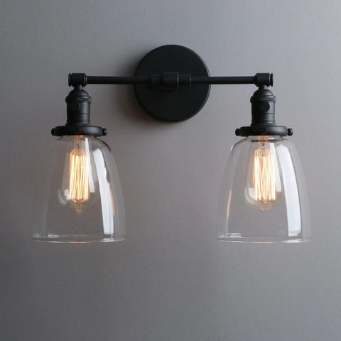 Retro Industrial 2-Light Wall Sconce Set With Dual 5.6 Inch Bell Shaped Clear Glass Lampshades, Black Finish For Bathroom Vanity