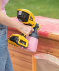 18V Cordless Paint And Stain Sprayer Delivering Slick HVLP Coatings No Wire Headaches Badass Battery Life Easy Peasy Handling in use outdoors.