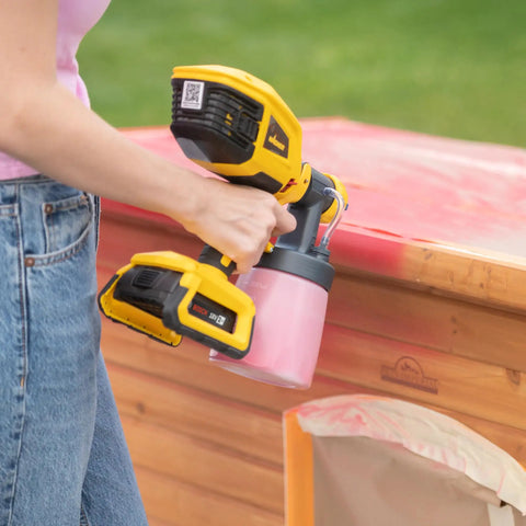 18V Cordless Paint And Stain Sprayer Delivering Slick HVLP Coatings No Wire Headaches Badass Battery Life Easy Peasy Handling in use outdoors.