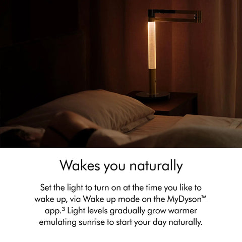 Bedroom setup with Solarcycle Morph Desk Light With Adaptive Daylight Tracking, casting warm light on bedside table, enhancing ambiance.