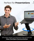 Man presenting using 3-In-1 Adjustable Laptop Stand, Book Stand, And Phone Holder With 360 Degree Rotating Display, Height Adjustable.
