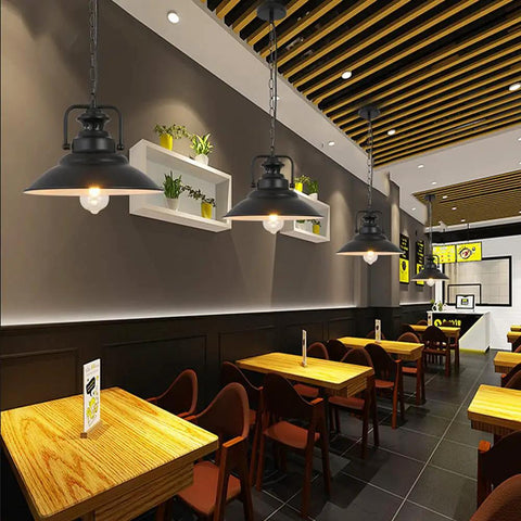 Old School Vintage Inspired Round Black Industrial Pendant Light With E27 Socket Wrought Iron Lampshade in a restaurant setting