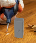Laminate Floor Repair Kit With Color Wax Blocks For Scratch Repair And Hole Filling shown on wooden surface with tool