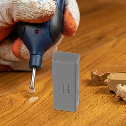 Laminate Floor Repair Kit With Color Wax Blocks For Scratch Repair And Hole Filling shown on wooden surface with tool