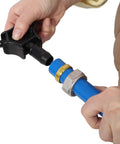 Hand connecting fittings to Boss Grade Blue Air Compressor Piping Tube 3/4 Inch X 200 Feet for tight seal setup.