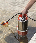 Powerful 1HP Submersible Sump Pump With Float Switch 3700GPH Stainless Steel For Fresh Water Mains Water And Pool Water Built Tough Orange Unit For Quick Home Draining being submerged in water.