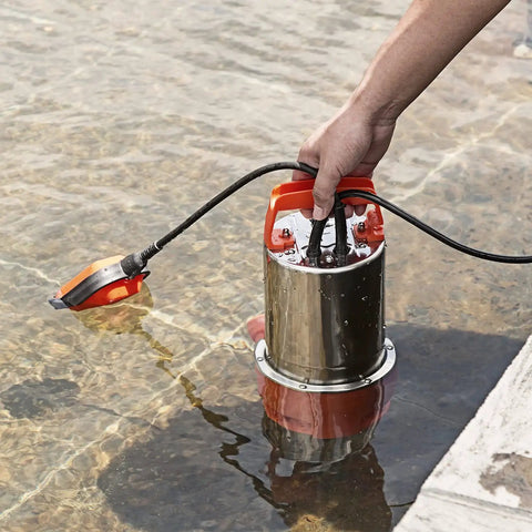 Powerful 1HP Submersible Sump Pump With Float Switch 3700GPH Stainless Steel For Fresh Water Mains Water And Pool Water Built Tough Orange Unit For Quick Home Draining being submerged in water.