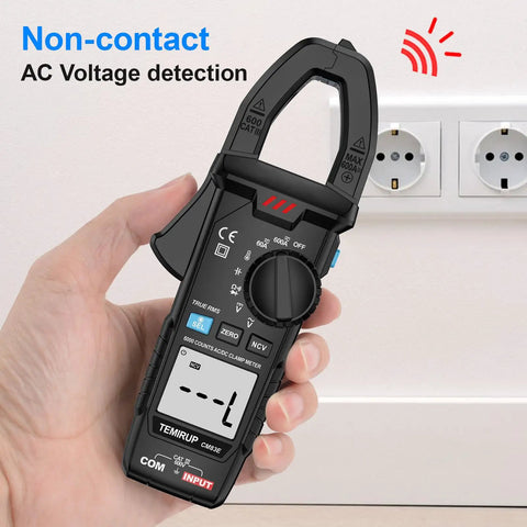 True RMS Clamp Meter For Auto Ranging 6000 Counts With 600A Capacity And Built In Flashlight Backlight Measures NCV AC DC Voltage And Current Continuity Capacitance Diode Resistance And Temperature For Car Home And Industrial Fixes, held near outlet