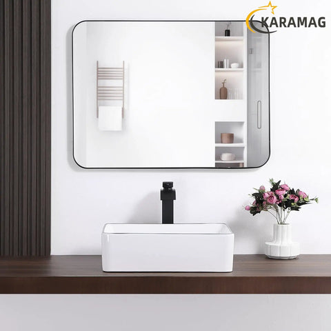 White Rectangle Vessel Sink For Bathroom Above Counter Porcelain Ceramic Basin With Black Rim Edge Modern European Inspired Design 18 Inch Exterior Sleek Small Sink Bowl For Bathrooms on wooden countertop with mirror and flowers