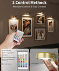 Hand holding remote for Rechargeable Magnetic LED Puck Lights For Wall, Wireless 2000mAh Battery, installed above art frames
