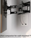 Recessed In Wall TV Media Box With Ventilated Cooling To Hide Streaming Boxes And Routers For A Straight Fire Media Setup Supporting Up To 22 Lbs For A Clean Cable Tangle Free Install mounted behind a TV, showing cable management.