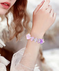 Woman wearing bracelet made of 100 Pcs Cherry Blossom Acrylic Flower Beads For Jewelry Making And Bracelet Charms, pink and blue gradient