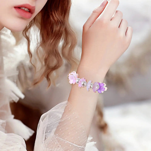 Woman wearing bracelet made of 100 Pcs Cherry Blossom Acrylic Flower Beads For Jewelry Making And Bracelet Charms, pink and blue gradient