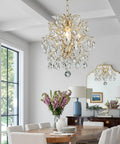 Top Tier Gold Crystal Raindrop Pendant Chandelier Featuring Durable Glass Tubes And Adjustable Chain Ceiling Light E26 Socket in dining room.