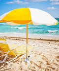Heavy Duty Beach Umbrella Sand Anchor Ground Screw Auger with Carry Bag securing a yellow umbrella on sandy beach.