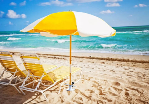 Heavy Duty Beach Umbrella Sand Anchor Ground Screw Auger with Carry Bag securing a yellow umbrella on sandy beach.