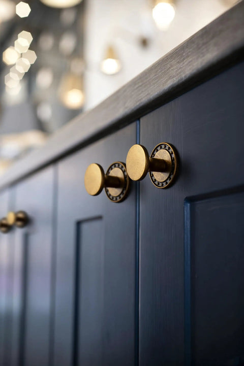 Antique Brass Cabinet Knobs With Backplate Beaded Round Hardware 6 Pack for kitchen on dark blue cabinet door.