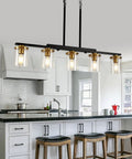 Top Notch Five Light Dining Room Fixture Featuring Clear Glass Shades That Give Any Kitchen Island A Kickin Farmhouse Chandelier Vibe While Building Sweet Warm Ambiance For Gatherings in modern kitchen setting.