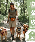 Person walking dogs in nature carrying 95-Piece Vet-Approved Pet First Aid Kit For Dogs And Cats With Outdoor And Travel Essentials in Guardian Orange bag