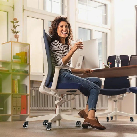Woman sitting on an office chair with Office Chair Wheels Universal Fit 3 Inch Roller Blade Casters Safe For Hardwood And Carpet Floors
