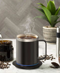 Ditch Lukewarm Sludge With This Smart Usb Heated Coffee Mug Using Precise Temperature Control And Heavy Duty Stainless Steel Build Plus Power Base And Leakproof Lid To Keep Your Daily Grind Piping Hot, featuring steaming coffee.