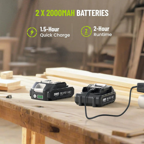 Two 2000mAh batteries for 21V Cordless Impact Driver Kit with charging cable on a wooden workbench in a workshop.