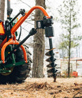 9 Inch Auger Bit For 3 Point Post Hole Digger With Fishtail Point HD Steel Digging Bit attached to tractor in field